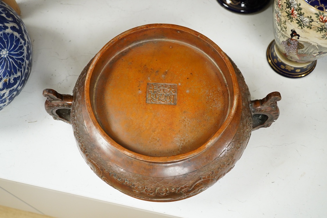 A large Chinese archaistic bronze censer, decorated in relief, with twin handles, 38cm in diameter